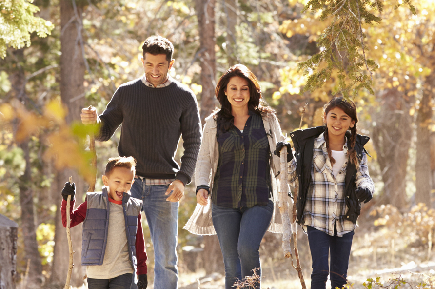 family walking through the woods