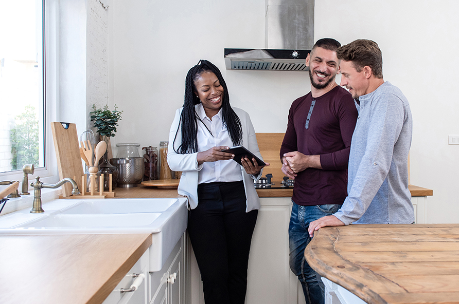 Couple looking at home-buying resources while shopping for a house with an agent