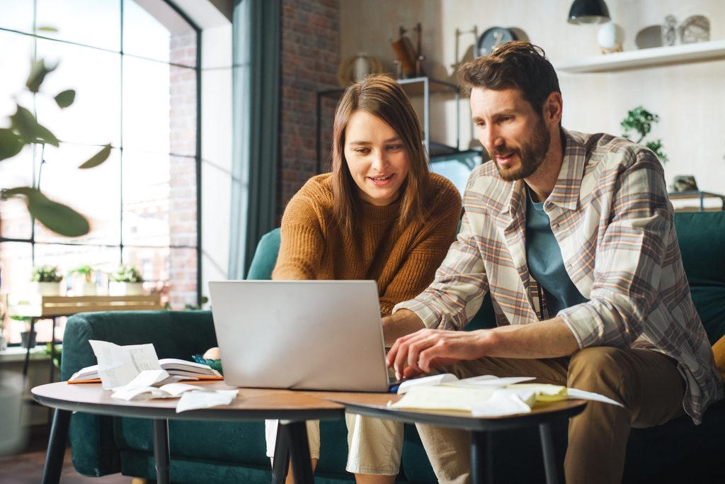 couple paying bills on computer