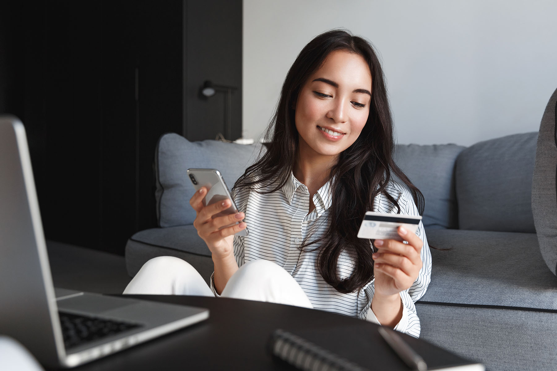 Woman using card on computer